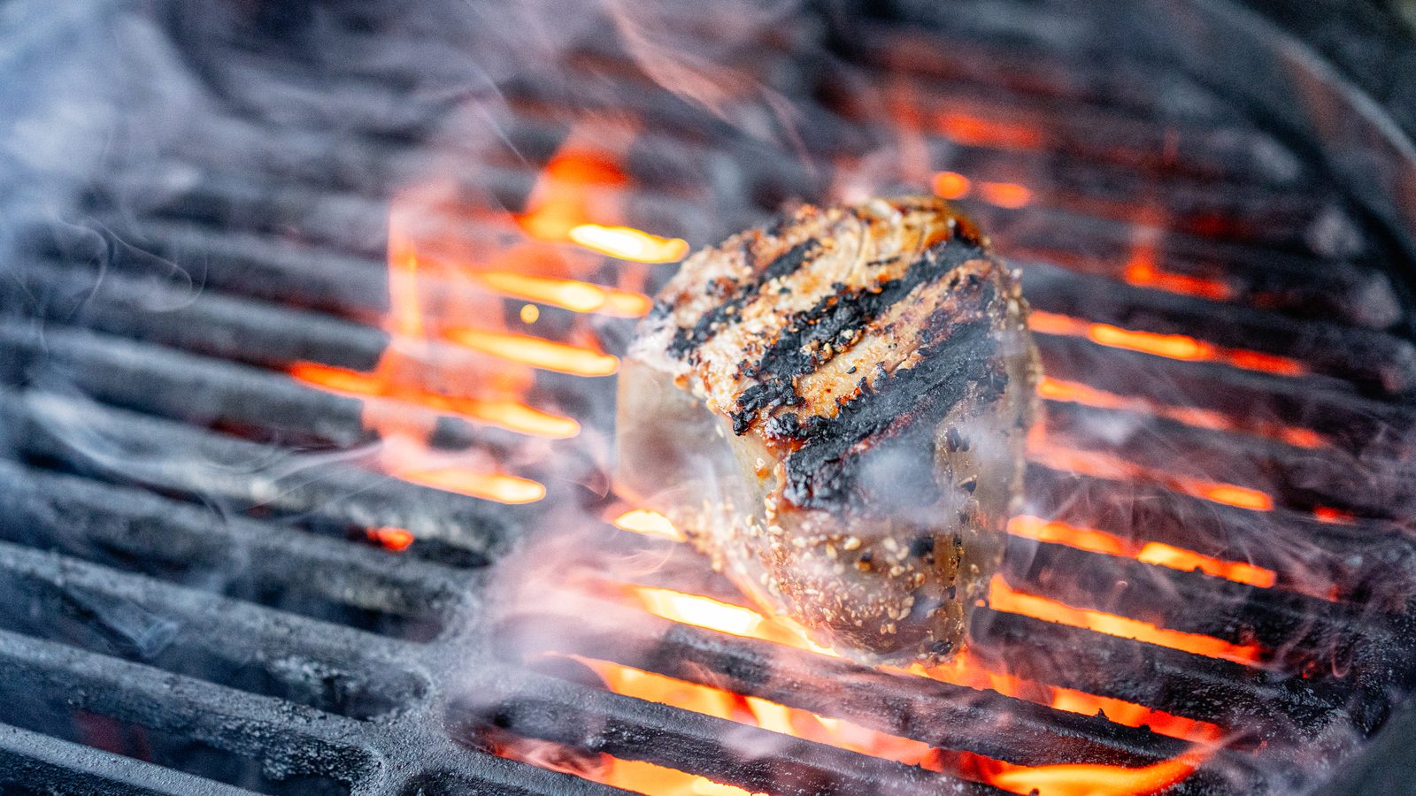 Steak searing over open flame